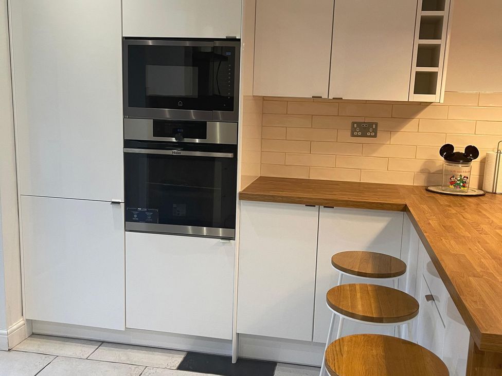 A kitchen with built-in oven and microwave at 15A Currier Lane Ashton-under-Lyne