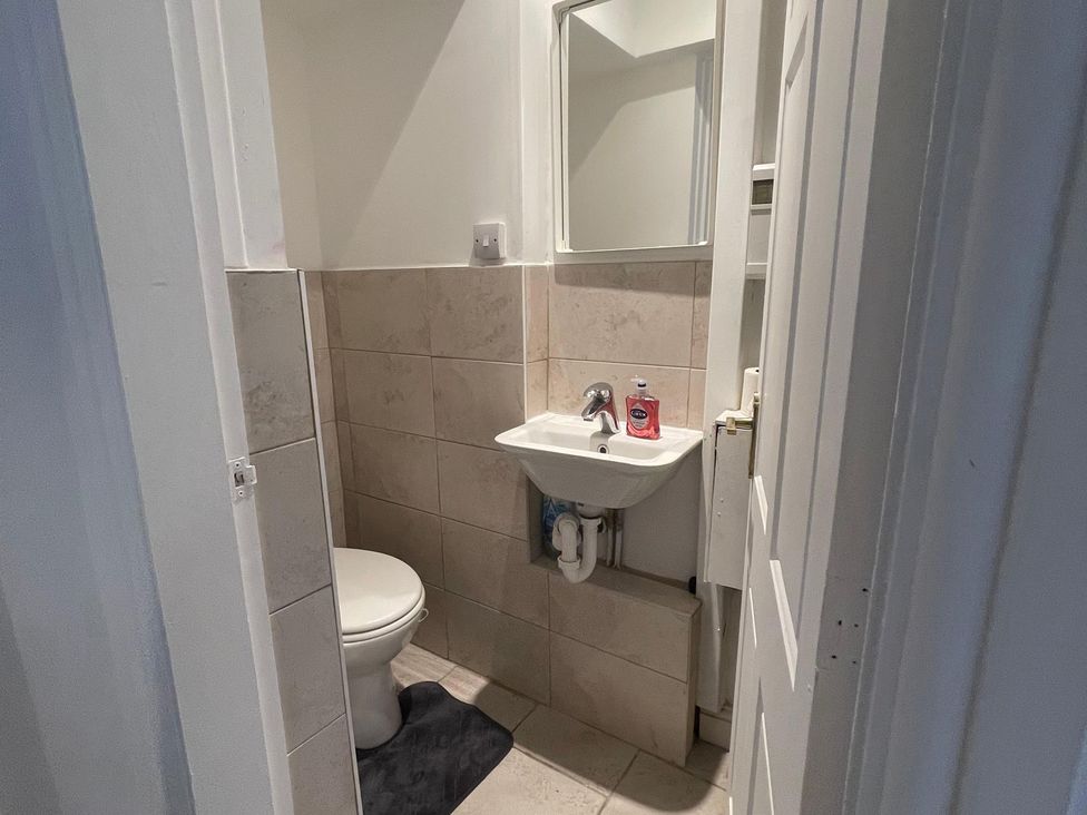 A bathroom with a toilet and sink at 15A Currier Lane Ashton-under-Lyne