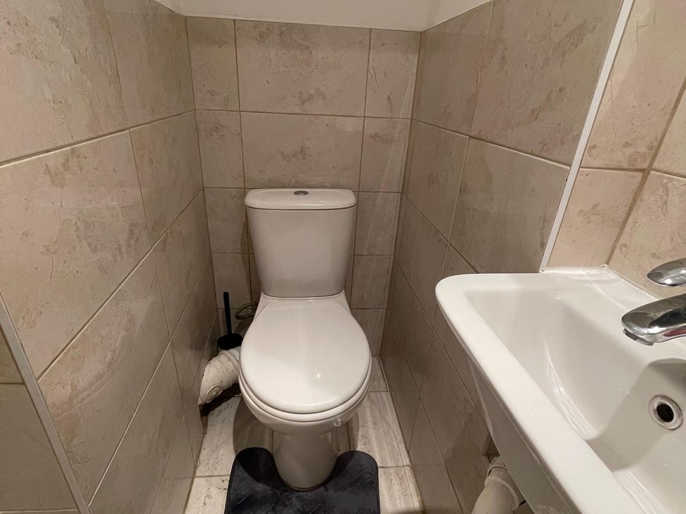 A bathroom with a toilet and sink at 15A Currier Lane Ashton-under-Lyne