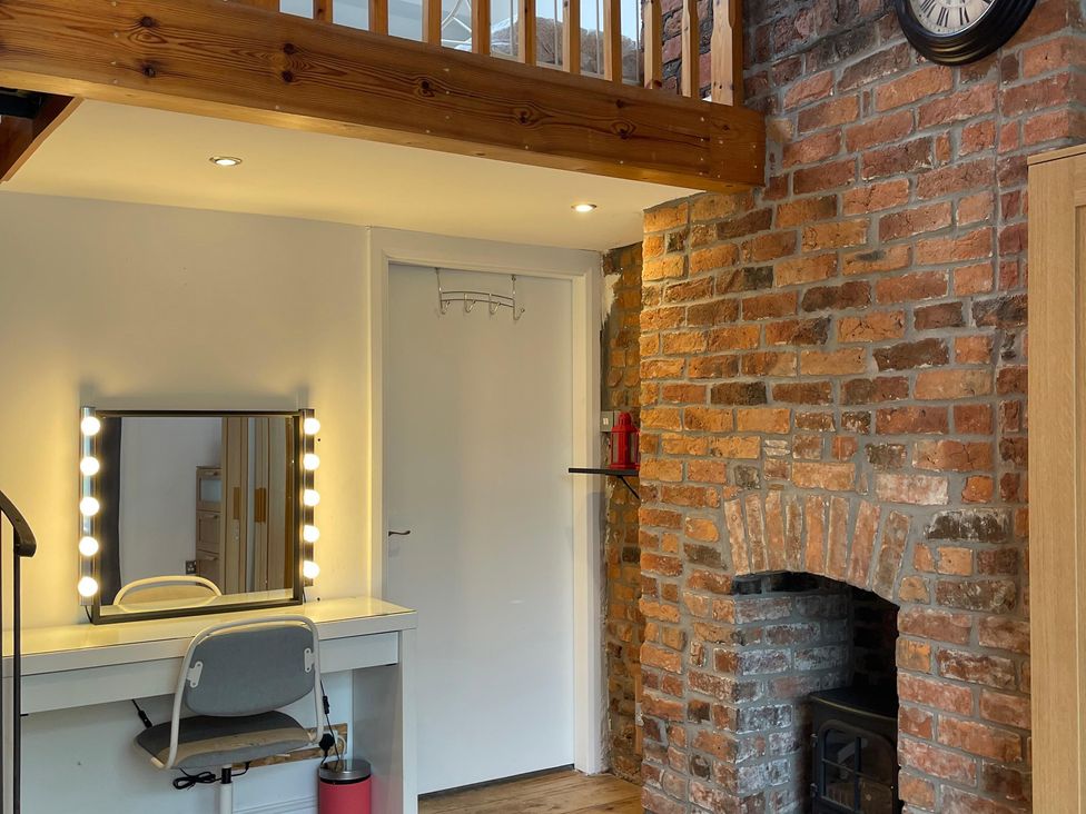 A dressing room with a vanity table and mirror at 15A Currier Lane Ashton-under-Lyne