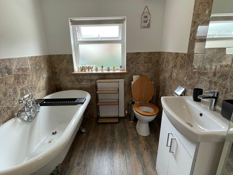 A bathroom with a bathtub and sink at 15A Currier Lane Ashton-under-Lyne