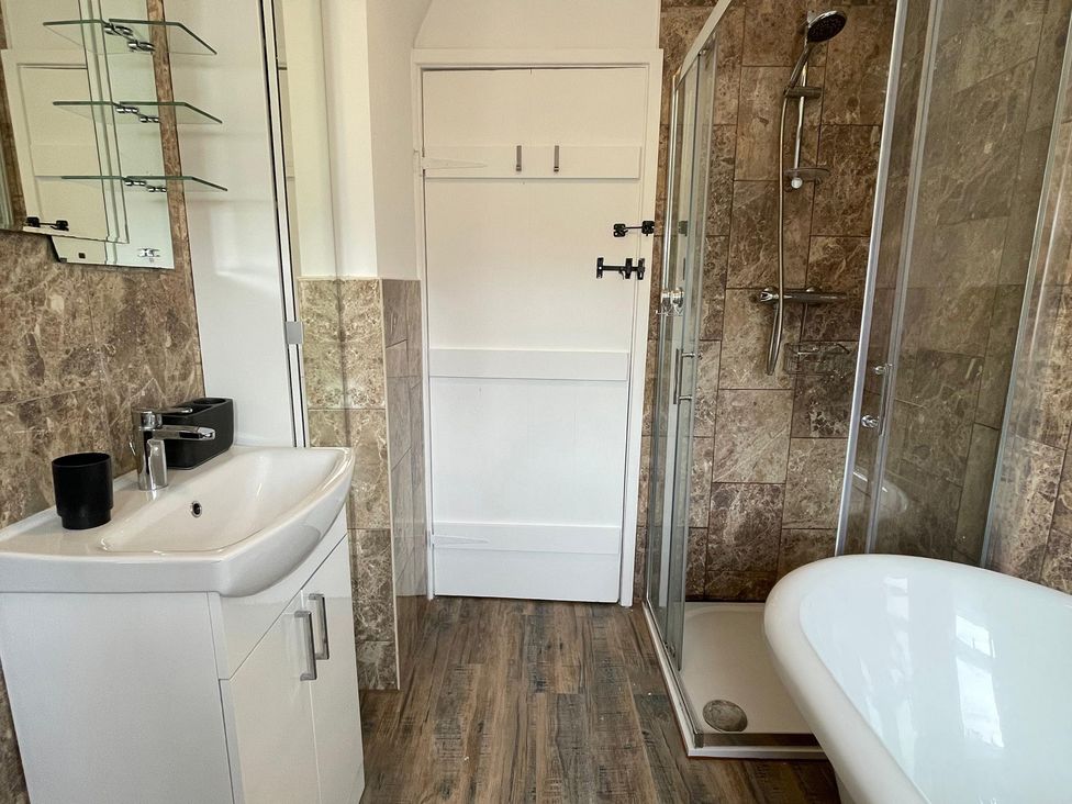 A bathroom with a sink, shower, and bathtub at 15A Currier Lane Ashton-under-Lyne