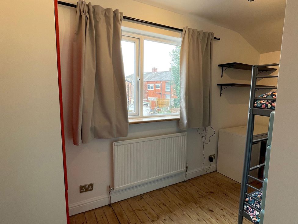 A bedroom with a window and bunk bed at 15A Currier Lane Ashton-under-Lyne