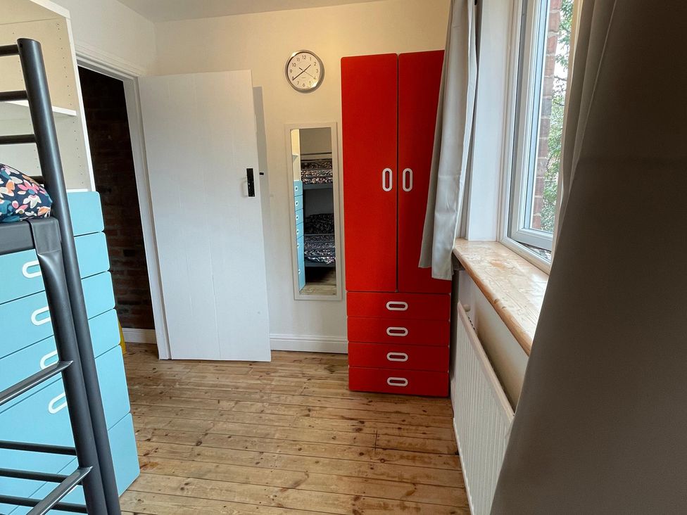 A bedroom with a bunk bed and wardrobe at 15A Currier Lane Ashton-under-Lyne