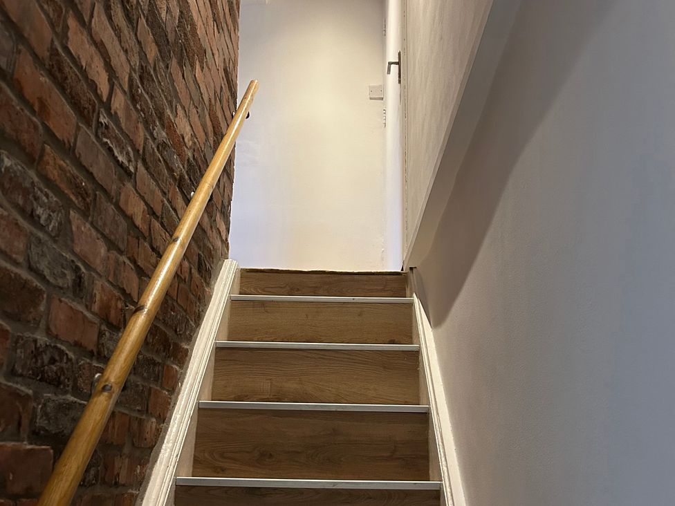 A staircase with wooden steps and a handrail at 15A Currier Lane Ashton-under-Lyne