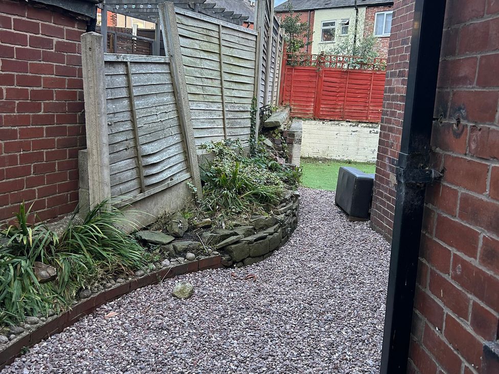 A garden pathway with gravel and fences at 15A Currier Lane Ashton-under-Lyne