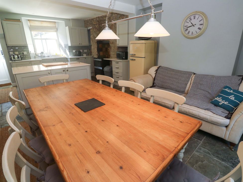 A kitchen with a dining table and chairs at Pedn Brose near Mousehole