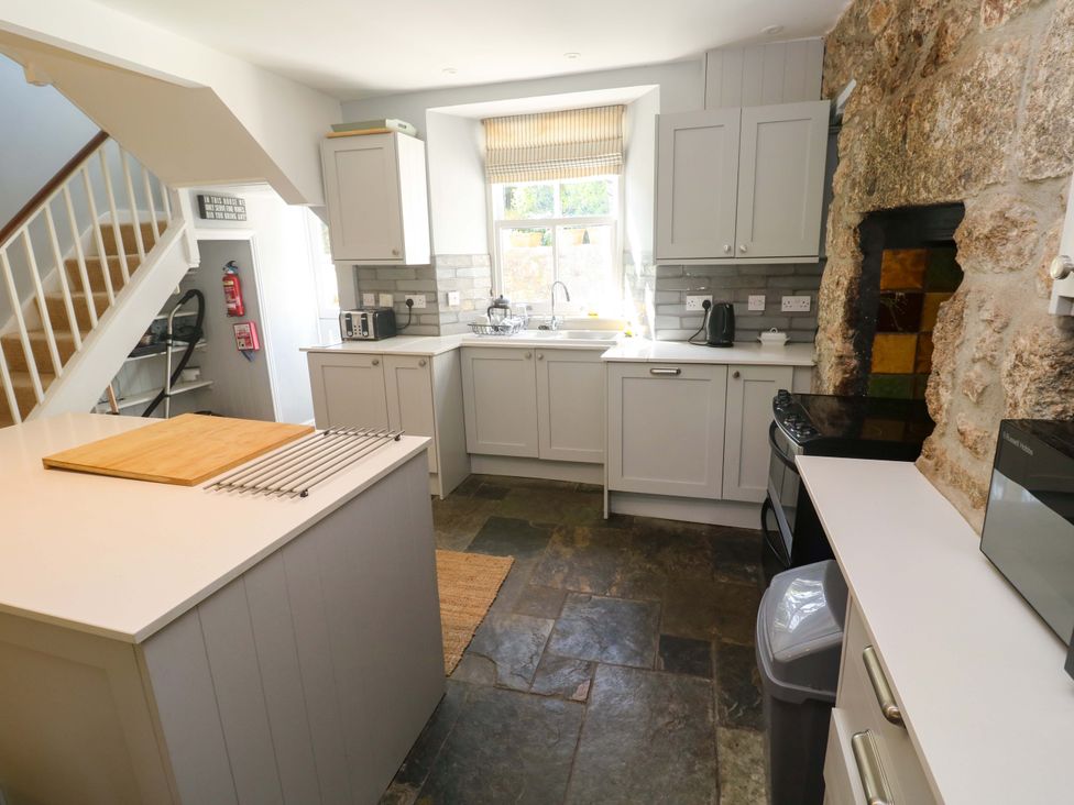 A kitchen with a stove and sink at Pedn Brose Near Mousehole
