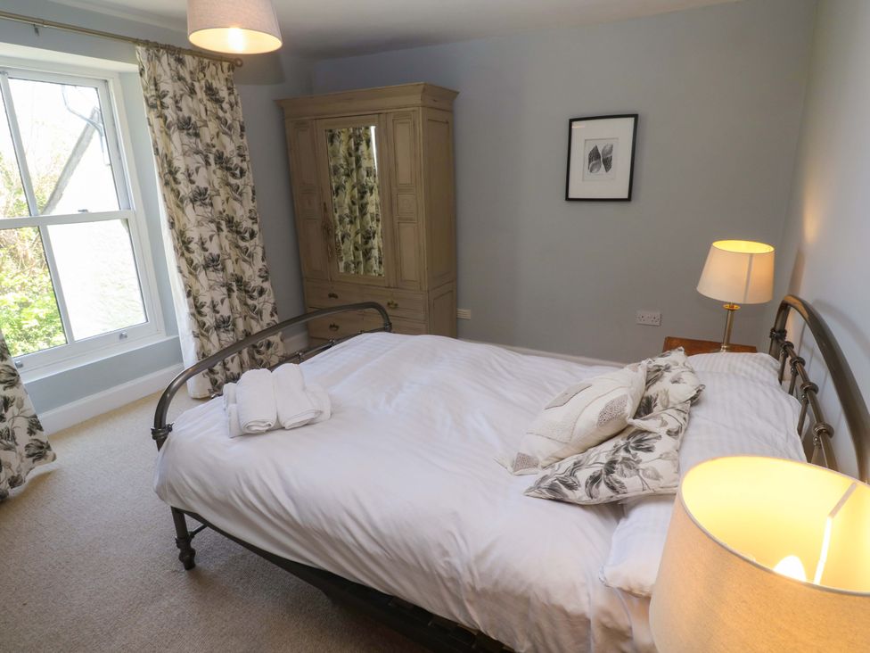A bedroom with a bed and wardrobe at Pedn Brose Near Mousehole
