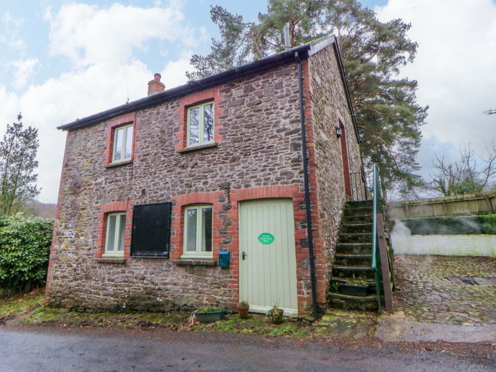An outdoor view of a stone house with windows and stairs at The Old Sunday School in Cwmwysg near Sennybridge