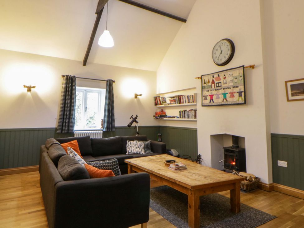 A living room with a sofa and coffee table at The Old Sunday School in Cwmwysg near Sennybridge
