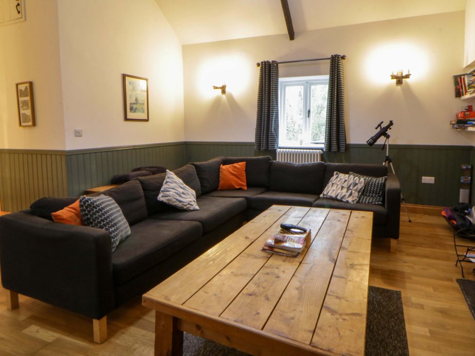 A living room with a sofa and coffee table at The Old Sunday School Cwmwysg near Sennybridge