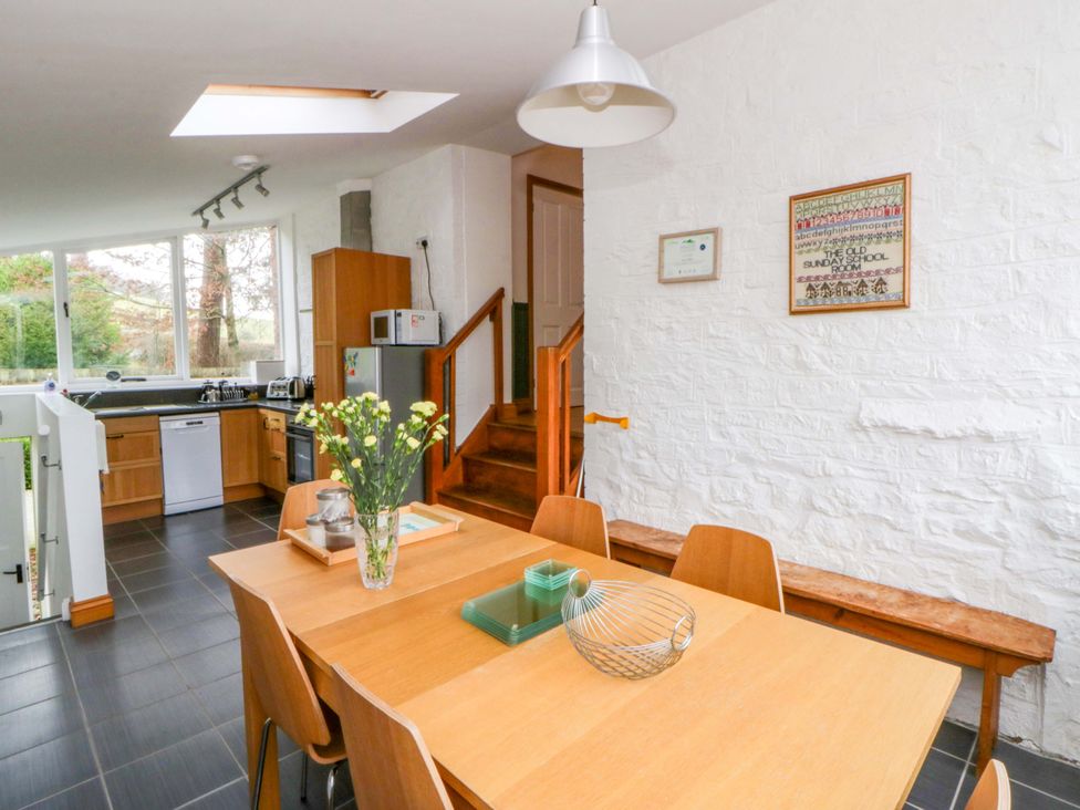 A kitchen with a dining table and stairs at The Old Sunday School in Cwmwysg near Sennybridge