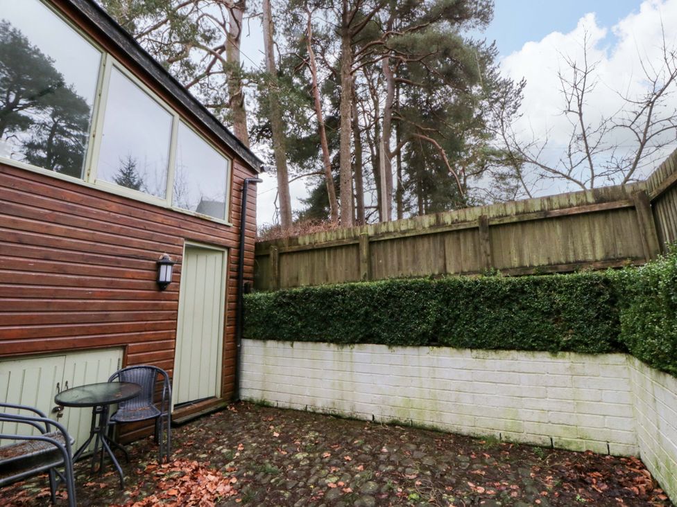 An outdoor area with a wooden wall and seating at The Old Sunday School Cwmwysg near Sennybridge