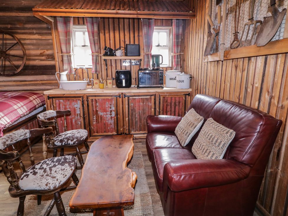 A living room with a sofa and coffee table at Rusty Barn in Limavady