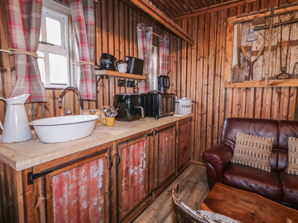 A kitchen with a sink and cabinets at Rusty Barn in Limavady