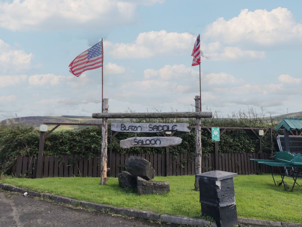 A signpost with flags at Blazin Saddle Saloon in Limavady