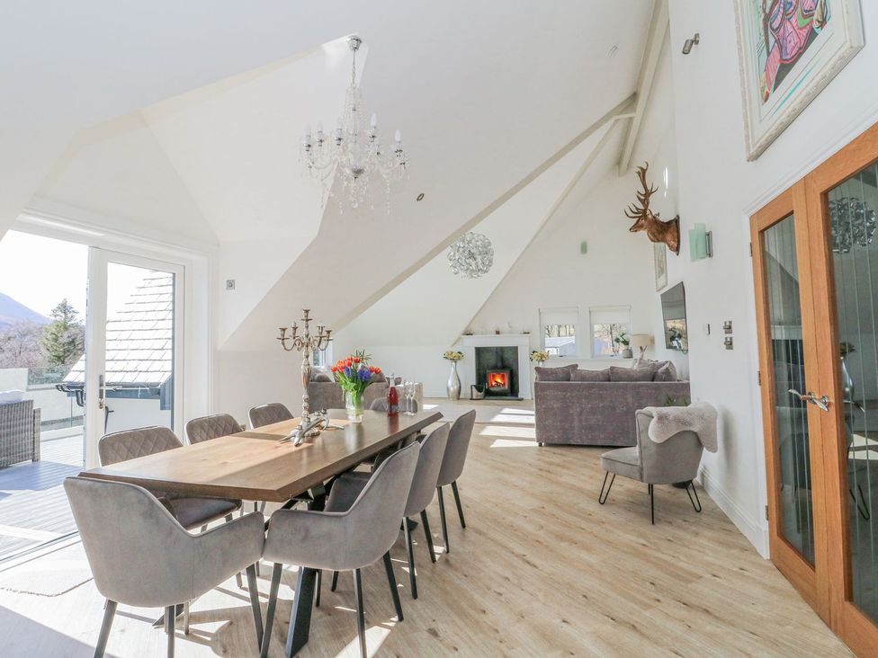 A dining room with a table and chairs at Macgregor Ranch Achnabobane near Spean Bridge