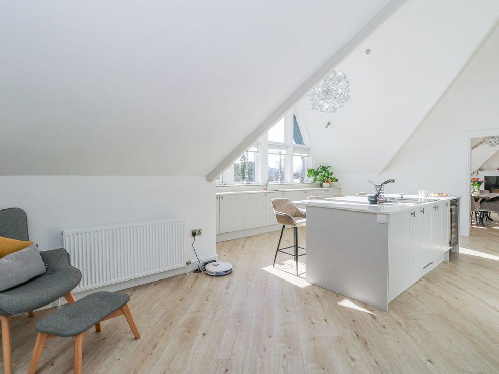 A kitchen with an island and seating at Macgregor Ranch Achnabobane near Spean Bridge