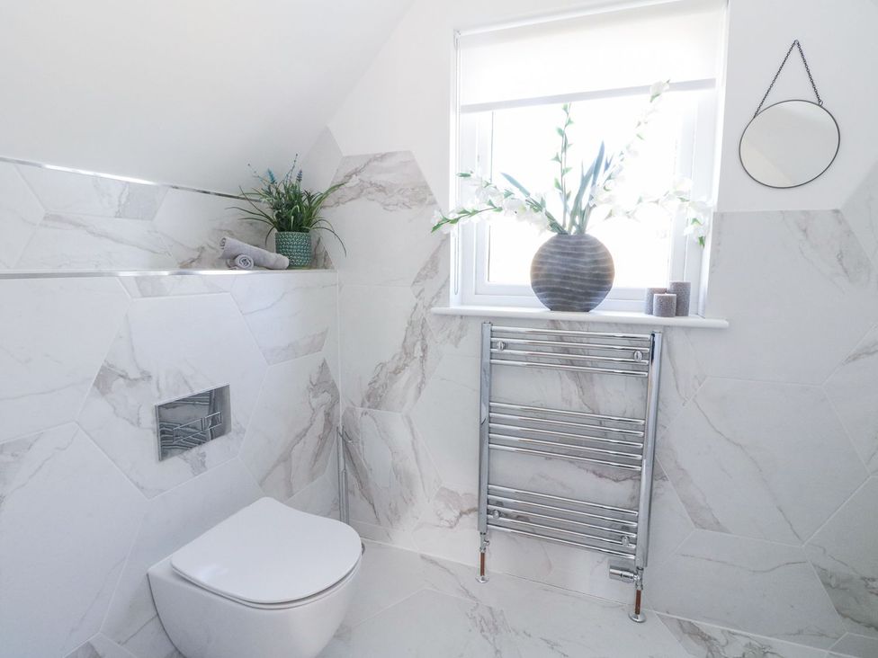 A bathroom with a toilet and a window at Macgregor Ranch Achnabobane near Spean Bridge