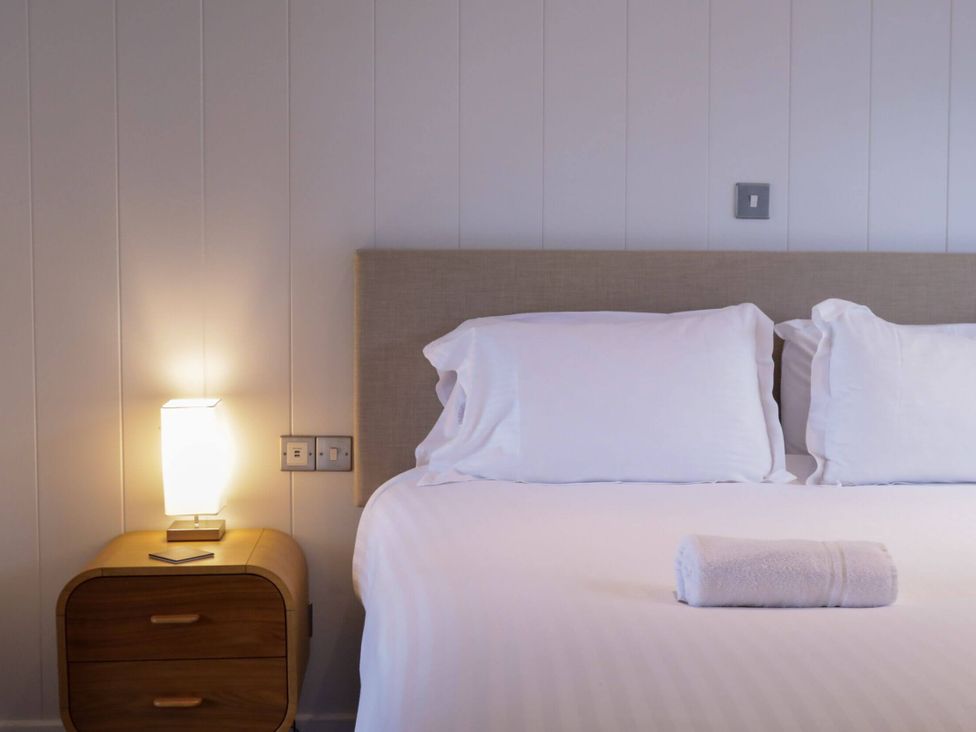 A bedroom with a bed and bedside lamp at Brayton in Aspatria