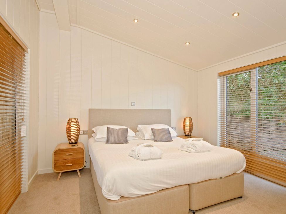 A bedroom with a bed and nightstand at Brayton in Aspatria