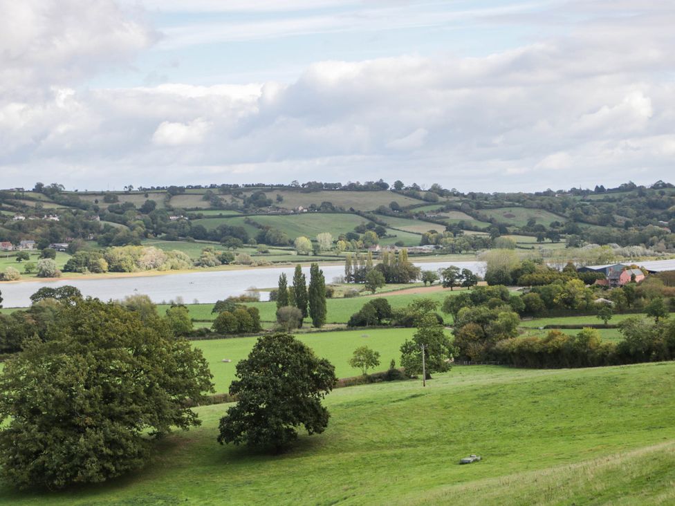 A view of fields, trees and a river at Redwood Cottage in Bristol