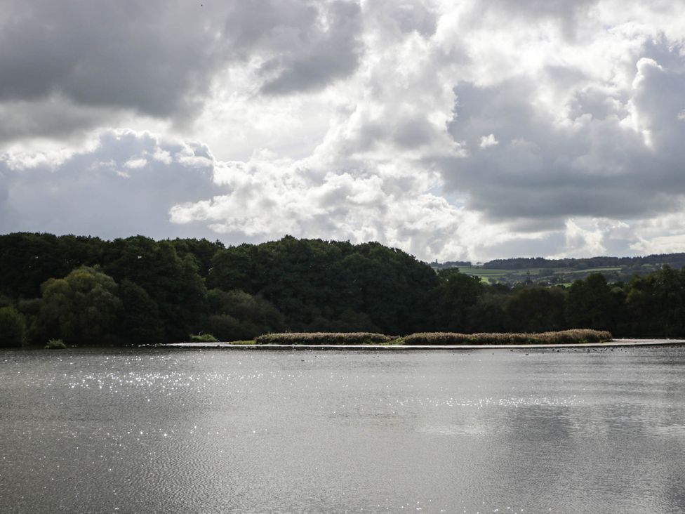 A view of water with trees and clouds at Redwood Cottage in Bristol