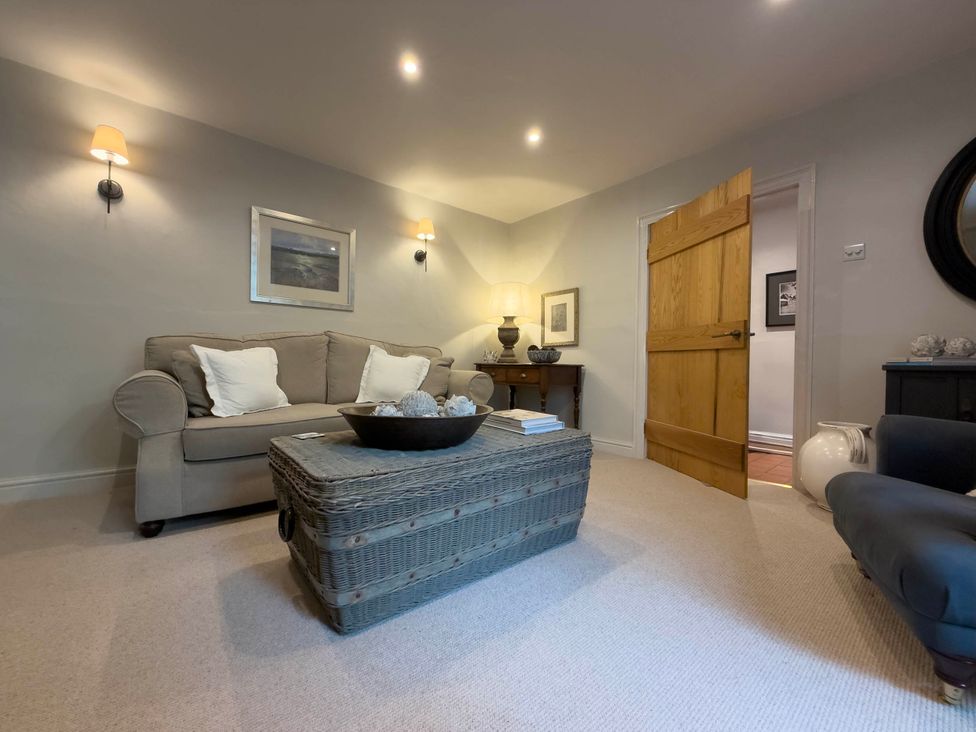 A living room with a sofa and coffee table at Redwood Cottage in Blagdon