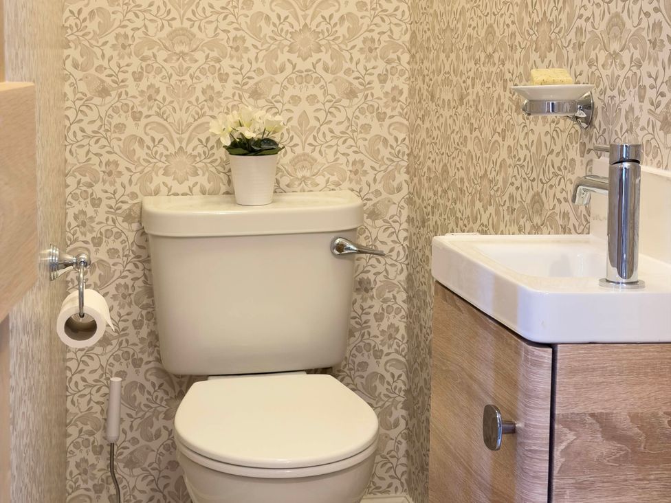 A bathroom with a toilet and sink at Redwood Cottage in Blagdon
