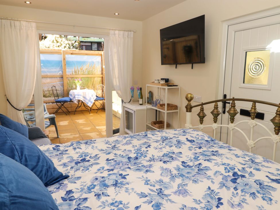 A bedroom with a bed and a television at Sea Folly