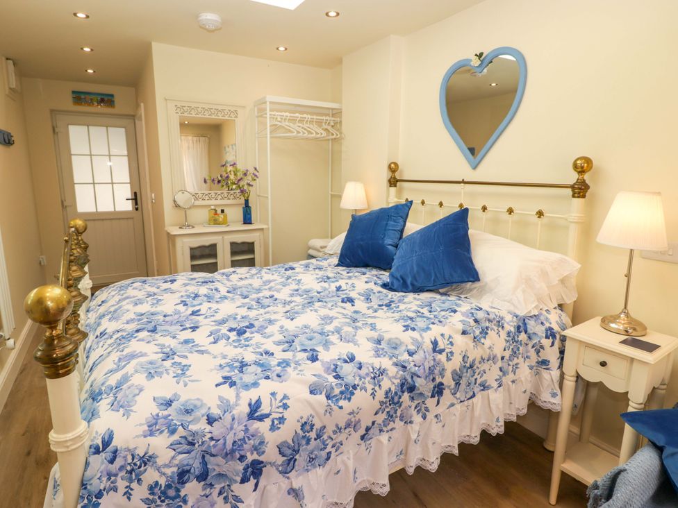 A bedroom with a bed and nightstand at Sea Folly