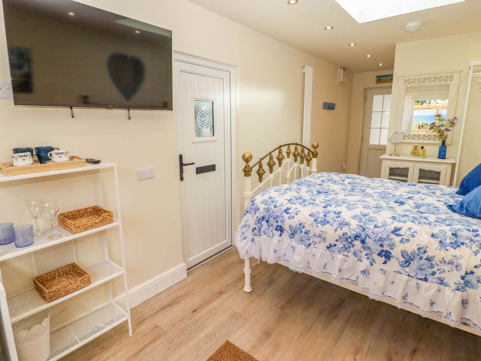 A bedroom with a bed and television at Sea Folly