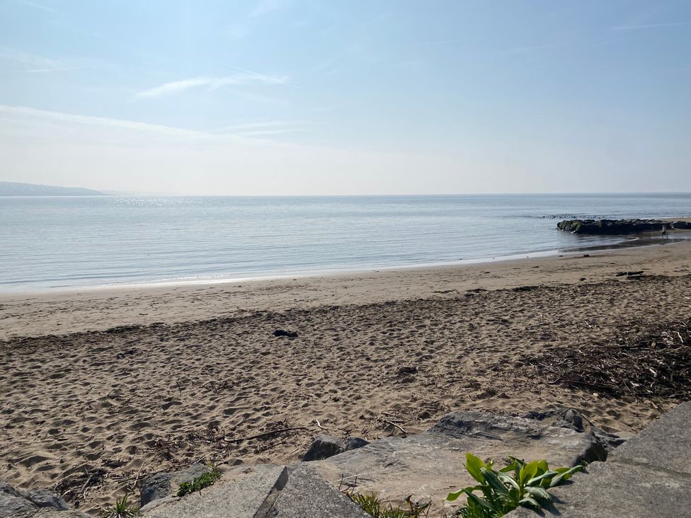 A beach with sand and water at Sea Folly in Porthcawl