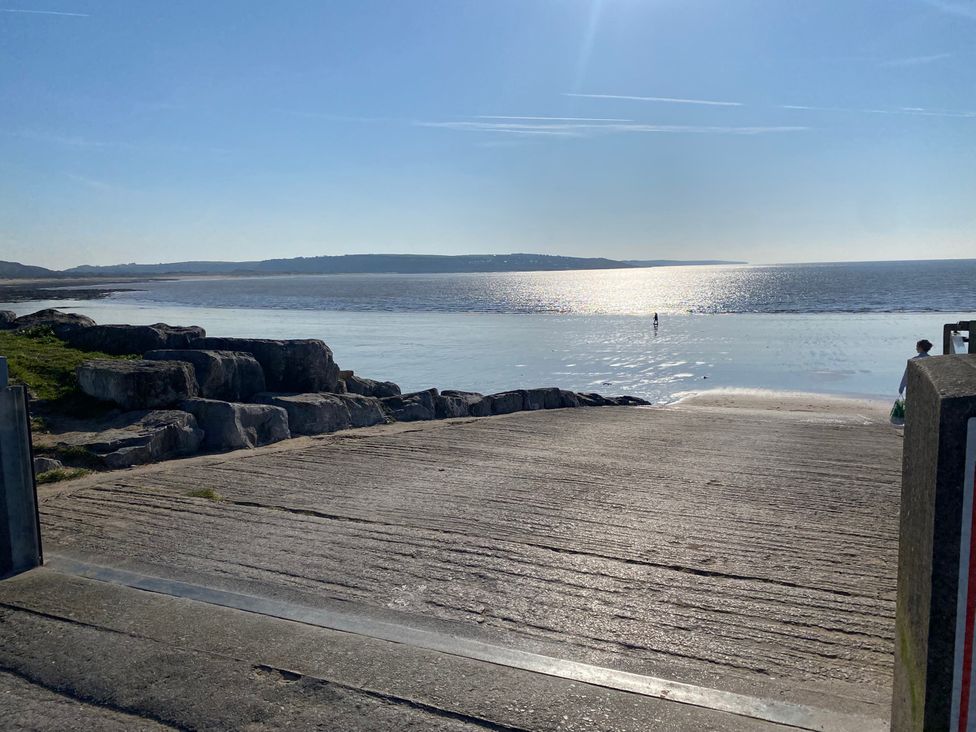 A beach scene with water and rocks at Sea Folly in Porthcawl