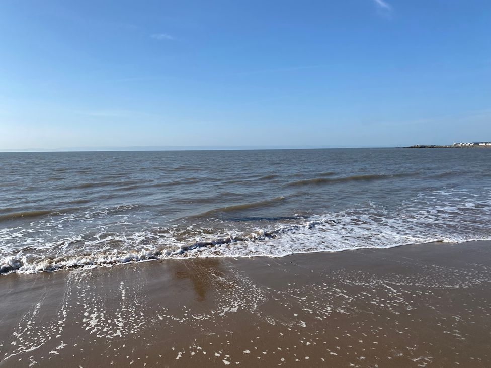 A beach with ocean waves at Sea Folly in Porthcawl