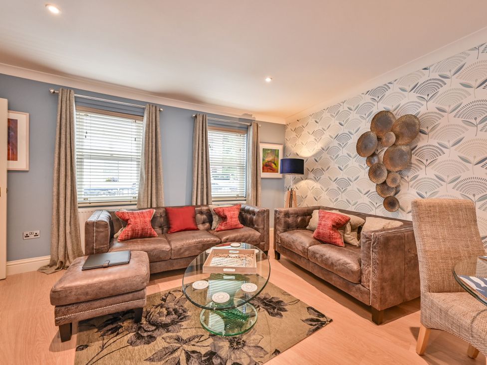 A living room with a sofa and coffee table at Lisburne Place in Torquay