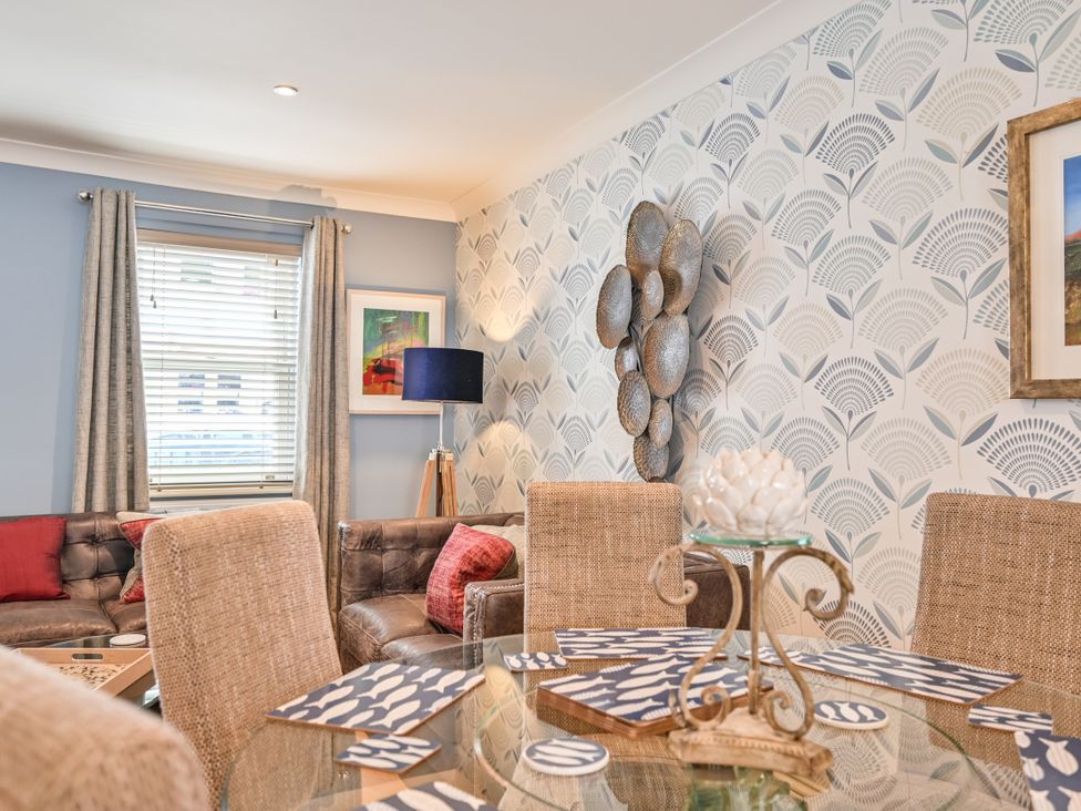 A dining room with table and chairs at Lisburne Place in Torquay