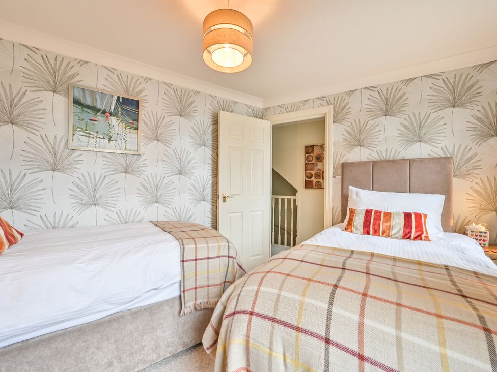 A bedroom with two beds and wall art at Lisburne Place in Torquay