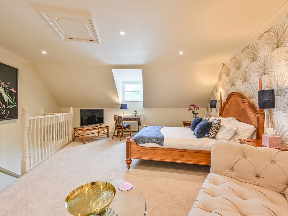 A bedroom with a bed and seating area at Lisburne Place in Torquay