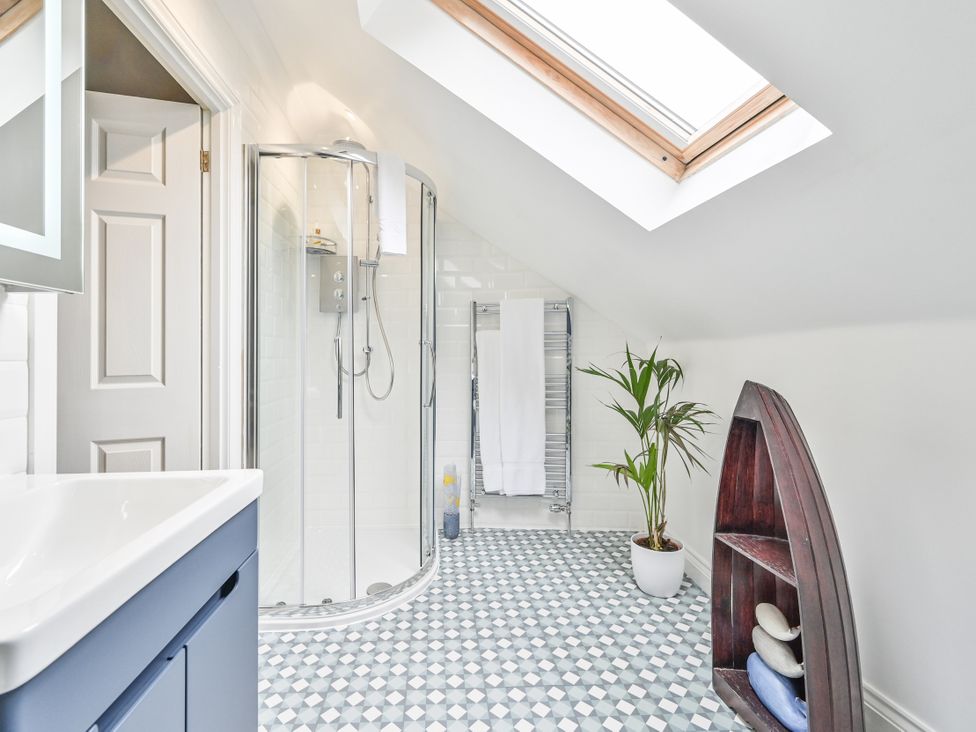 A bathroom with a shower and sink at Lisburne Place in Torquay