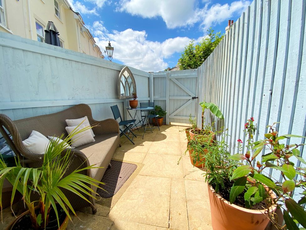 An outdoor area with a sofa and table at Lisburne Place in Torquay