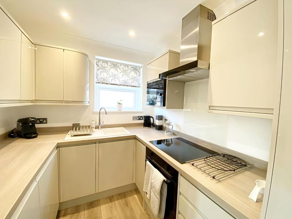 A kitchen with a sink and kettle at The Degas Sea View Suite in Torquay