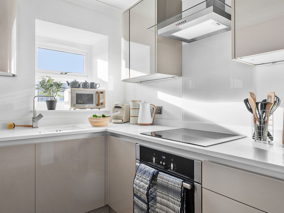 A kitchen with sink and appliances at The Renior Sea View Suite in Torquay