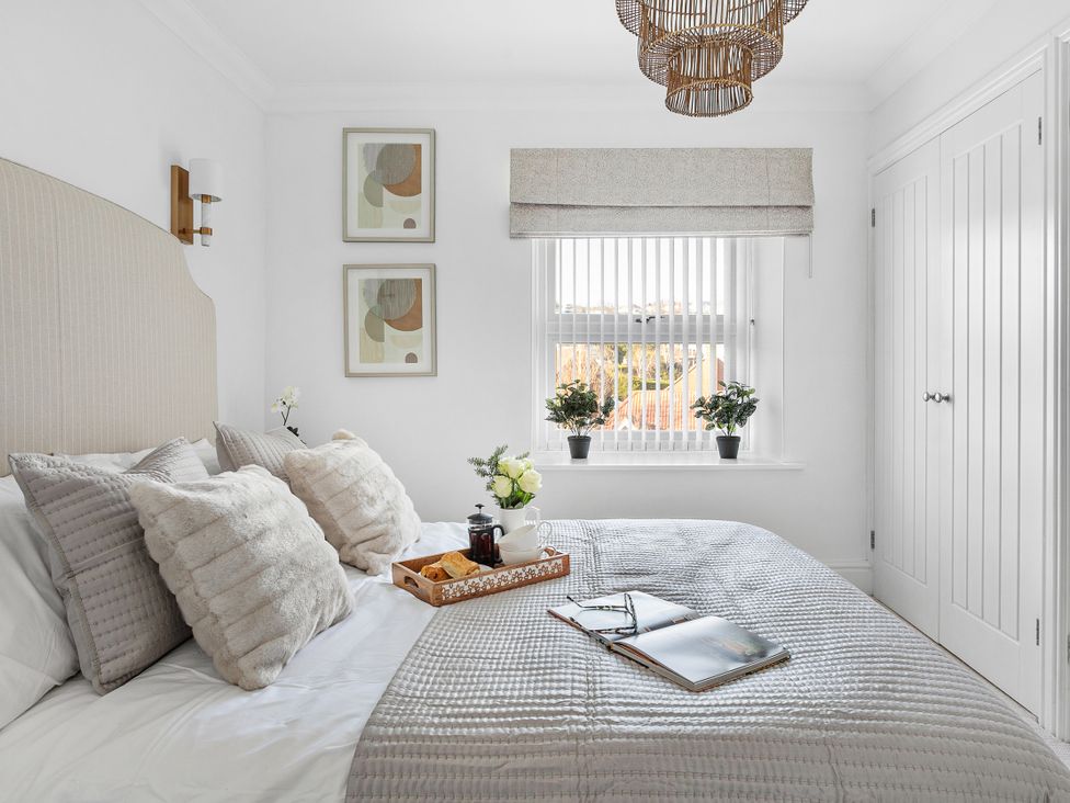 A bedroom with a bed and artwork at The Renior Sea View Suite in Torquay