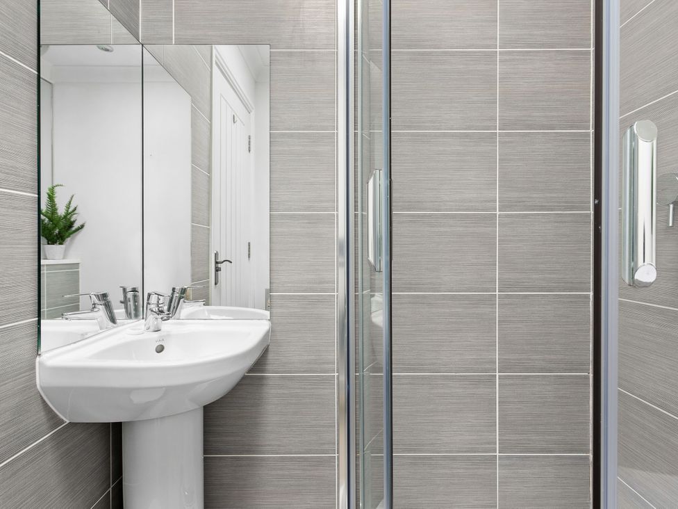 A bathroom with a sink and shower at The Renior Sea View Suite in Torquay