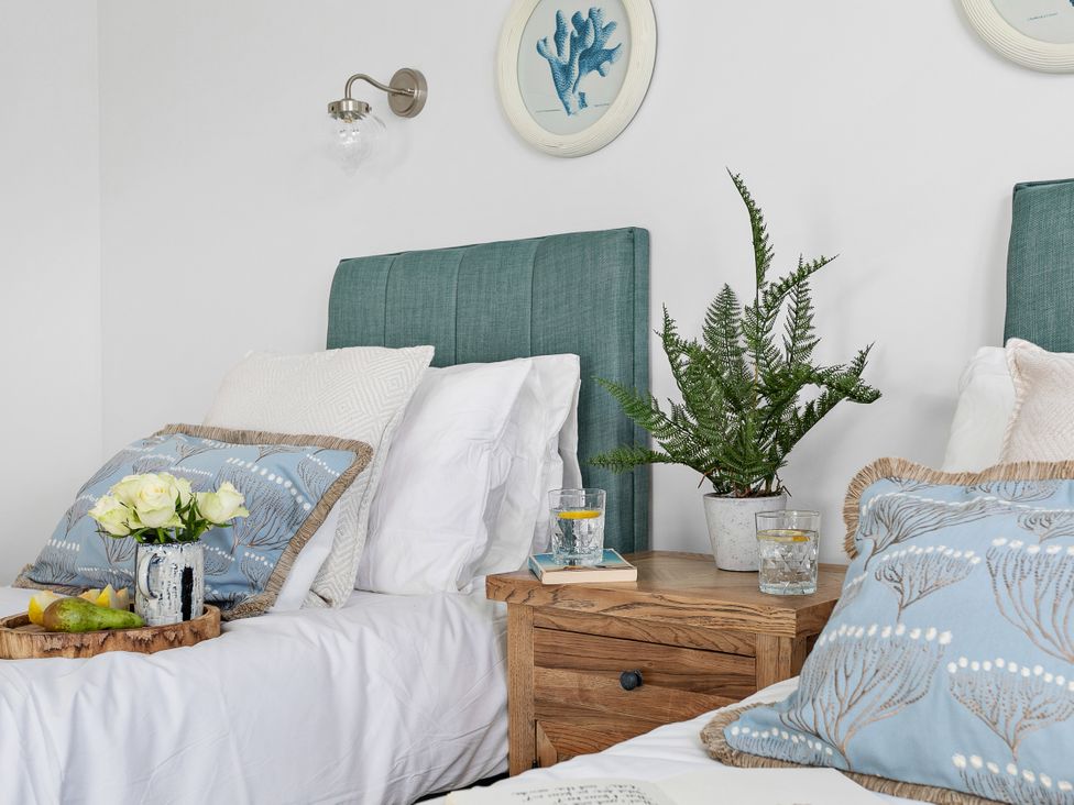 A bedroom with two beds and decor at The Renior Sea View Suite in Torquay