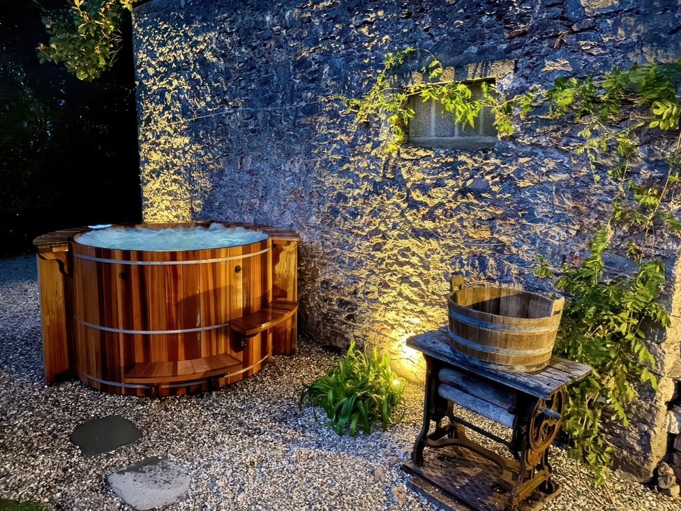 An outdoor area with a hot tub and a wooden barrel at St Anne's Manor Torquay