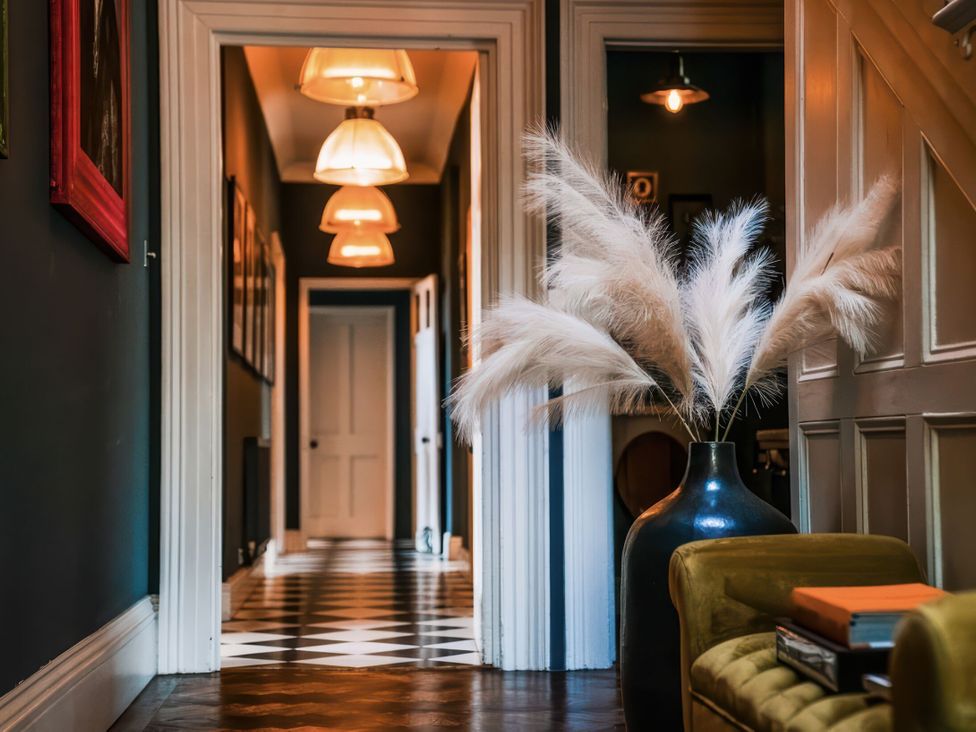 A hallway with a vase and pampas grass at St Anne's Manor in Torquay