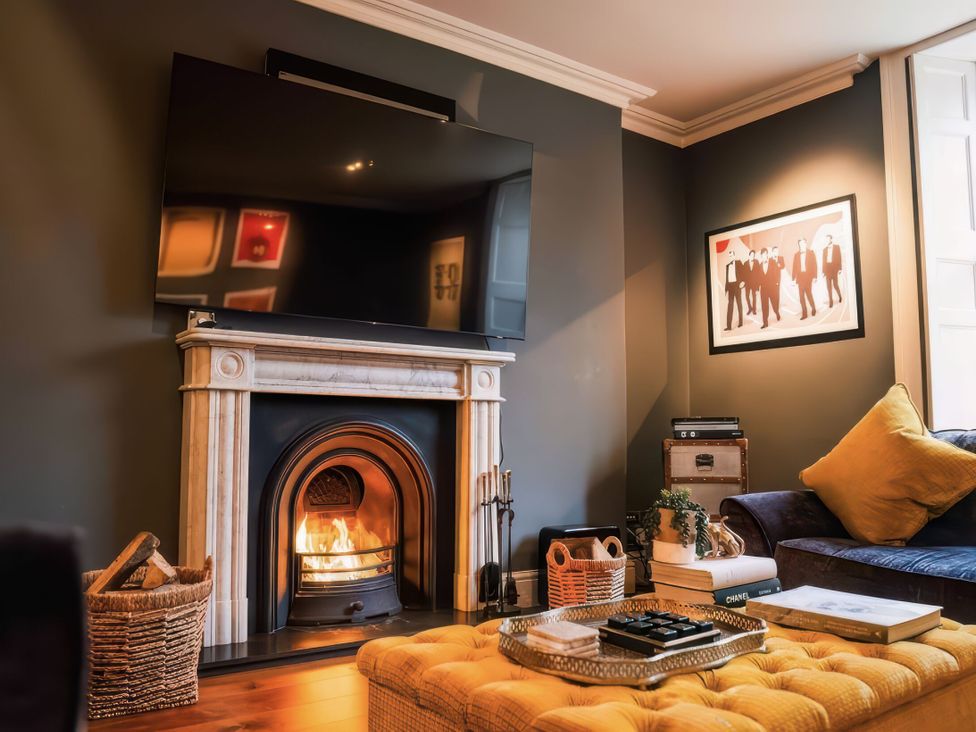 A living room with a television and fireplace at St Anne's Manor in Torquay